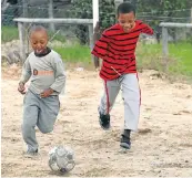  ??  ?? FLASHBACK: William Smith, right, plays soccer with Rompie Erasmus after he lost his arms at the age of 12 in 2011