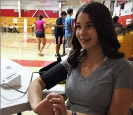  ??  ?? UPPER RIGHT: Incoming Brawley freshman Madolyn Tigert has her blood pressure checked.