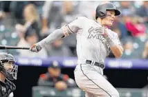  ?? DAVID ZALUBOWSKI/AP ?? Derek Dietrich was a triple short of the cycle on Sunday against the Rockies. He hit .438 on the road trip for Miami.