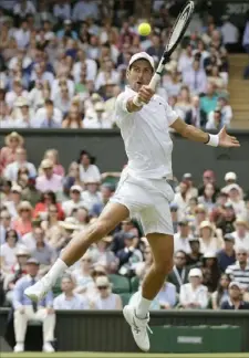  ?? Associated Press ?? Novak Djokovic goes airborne for a return Wednesday in his quarterfin­al match against David Goffin.