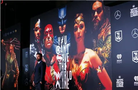  ?? — REUTERS FILE ?? Star Ben Affleck stands before the Justice League poster during its world premiere in Los Angeles in 2017. Director Zack Snyder is releasing his “Snyder Cut” of the film on streaming service HBO Max.