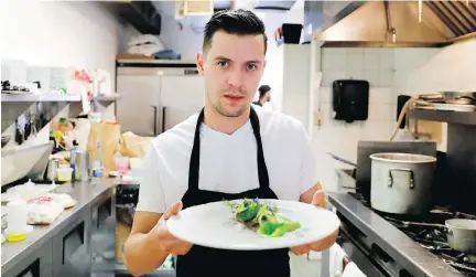  ?? PHOTOS: ALLEN MCINNIS ?? Prince chef Charles-Antoine Malenfant-Beaulieu delivers a delicious dish of halibut that’s paired with a watercress cream and lemon butter, and topped with a salad made with sea parsley, arugula and dill.