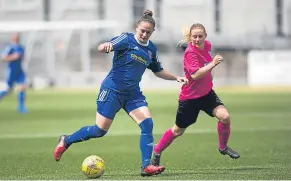  ??  ?? Forfar Farmington’s new signing from Jeanfield, Danni McGinley (blue), takes on a Buchan Ladies defender in their SWPL2 4-0 success.