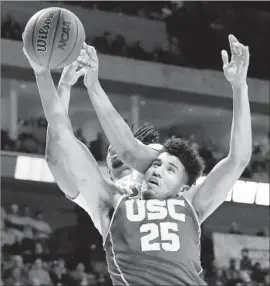  ?? Sue Ogrocki Associated Press ?? USC FORWARD Bennie Boatwright (25) is fouled by Southern Methodist’s Ben Moore during the second half. Boatwright scored 14 points in USC’s 66-65 victory.