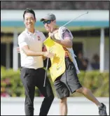  ?? Associated Press ?? FANTASTIC FINISH
Kevin Na, left, embraces caddie Kenneth Harms after winning the final round of the Sony Open golf tournament on Sunday at Waialae Country Club in Honolulu.
