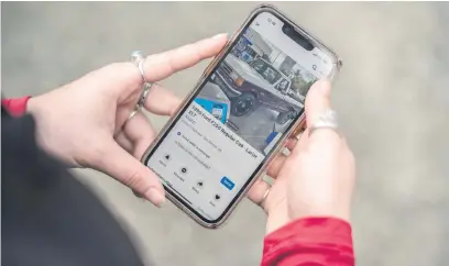  ?? Picture: AFP ?? CONQUERING. A Facebooker searches for used cars on the social network’s marketplac­e, a popular feature that connects buyers and sellers.