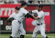  ?? THE ASSOCIATED PRESS ?? New York Yankees outfielder­s Brett Gardner, left, Giancarlo Stanton, center, and Aaron Hicks celebrate after the Yankees beat the Cleveland Indians 5-2in a baseball game, Saturday in New York.