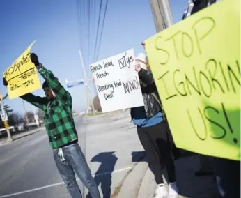  ?? MELISSA RENWICK/TORONTO STAR ?? Brandon Mallach, left, protests in front of Ernest C. Drury School for the Deaf in Milton.