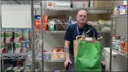  ?? SUBMITTED PHOTO ?? Paul Dunbar, an Air Force Veteran and eight-year volunteer, assists in the food pantry by bagging items and assisting Veterans to their cars at Coatesvill­e VA Medical Center on March 28, 2023. The pantry helps Veterans who are finding it difficult to maintain adequate food supply for themselves and their families.