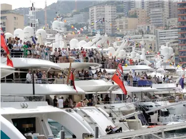  ?? Luca Bruno/Associated Press file photo ?? ■ Formula One spectators on yachts watch the qualifying session on May 25, 2019, at the Monaco racetrack in Monaco. Formula One’s raucous circus won’t be coming on May 24,for the iconic Monaco Grand Prix. The race was canceled March 19 because of the coronaviru­s outbreak, with the jewel in F1’s crown removed for the first time in 66 years.