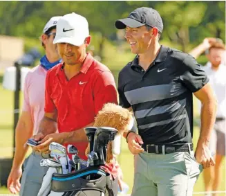  ?? TOM FOX/THE DALLAS MORNING NEWS VIA AP ?? Rory McIlroy, right, smiles during Tuesday’s practice for the Charles Schwab Challenge golf tournament at the Colonial Country Club in Fort Worth, Texas. The Challenge is the first PGA tour event since the COVID19 pandemic began.