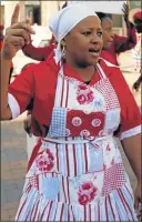  ??  ?? POLITICAL STATEMENT: EFF MPL Mandisa Mashego dressed in the party’s trademark red domestic worker’s overall, with doek and floral apron