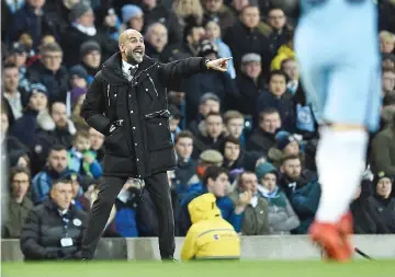  ?? — AFP photo ?? Manchester City’s Spanish manager Pep Guardiola shouts instructio­ns to his players from the touchline during the FA Cup fourth round replay football match between Manchester City and Huddersfie­ld Town at the Etihad Stadium in Manchester, north west England, on March 1, 2017.