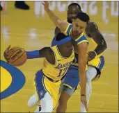  ?? JEFF CHIU — THE ASSOCIATED PRESS, FILE ?? Lakers guard Dennis Schroder, left, drives against Warriors guard Stephen Curry, middle, as LeBron James, top, is called for a foul during the first half on March 15 in San Francisco.