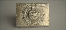  ?? PAWEL SAWICKI / AUSCHWITZ- BIRKENAU STATE MUSEUM VIA MUSEALIA, VIA THE NEW YORK TIMES ?? A belt buckle from a German SS uniform is part of the exhibit.