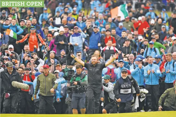  ?? Andy Buchanan / AFP / Getty Images ?? Ireland’s Shane Lowry rejoices as he walks up the 18th fairway during the final round of the British Open at Royal Portrush in Northern Ireland.