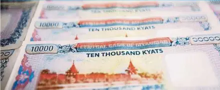  ?? BLOOMBERG PIC ?? The World Bank says state-owned lenders’ assets slid 14 per cent to 16.5 trillion kyat while privatesec­tor banks climbed 27 per cent to 23.3 trillion kyat at the end of June last year.