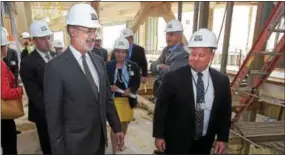  ?? PETE BANNAN – DIGITAL FIRST MEDIA ?? Gov. Tom Wolf tours Bryn Mawr Hospital’s new $200 million, 200,000-square-foot, patient pavilion Thursday. Wolf was joined by Ivan Scott, director of Nursing Operations at Bryn Mawr Hospital, as they took a brief tour in the still under constructi­on...