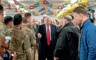  ?? AP ?? President Donald Trump visits members of the military at a dining hall at Al Asad Air Base, Iraq.