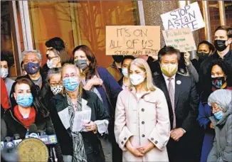  ?? Kena Betancur AFP/Getty Images ?? PEOPLE ATTEND a news conference against anti-Asian violence Tuesday in New York, one day after a 65-year-old Asian American woman was violently attacked on a nearby sidewalk.