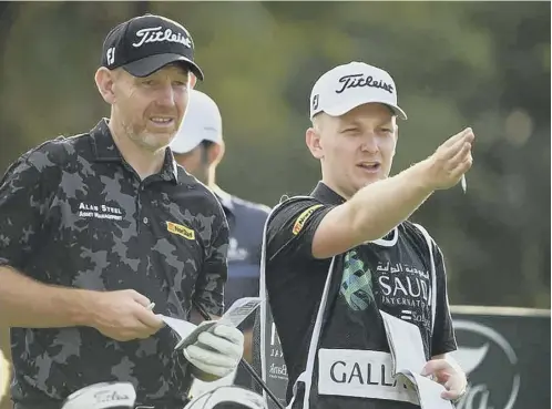  ??  ?? Stephen Gallacher and son/caddie Jack during the Saudi Internatio­nal at Royal Greens Golf and Country Club in February