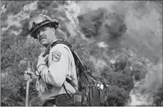  ?? RINGO H.W. CHIU/AP PHOTO ?? A crew member with California Department of Forestry and Fire Protection battles a brushfire Saturday on the hillside in Burbank.