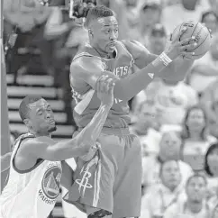  ?? Dwight Howard pulls one of his 16 rebounds away from the Warriors’ Harrison Barnes during the second quarter. ??