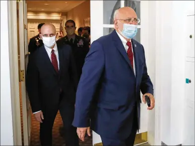  ?? ALEX BRANDON / AP ?? Food and Drug Administra­tion Commission­er Dr. Stephen Hahn trails Dr. Robert Redfield, director of the Centers for Disease Control and Prevention, on their way to a White House briefing on the coronaviru­s May 15.