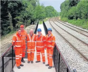  ??  ?? ●● MP David Rutley and Coun Harold Davenport with Network Rail staff at the restored section of rail line between Middlewood and Disley