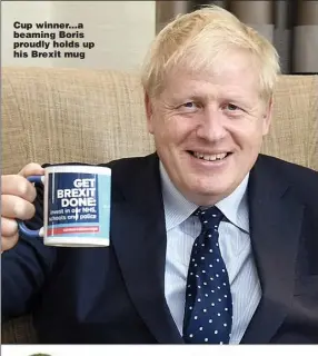  ??  ?? Cup winner...a beaming Boris proudly holds up his Brexit mug