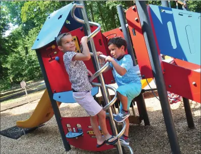  ?? Photo by Ernest A. Brown ?? Luis Garcia III, 6, left, and his friend, Bentley Setaro, also 6, both of Cumberland, enjoy the brand new children’s playground on the Cumberland Monastery grounds in Cumberland Tuesday. The playground is shaded and suited for youngsters of all ages.