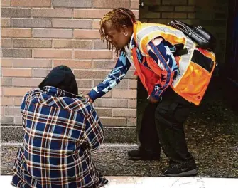  ?? Paul Chinn / The Chronicle 2019 ?? Cherie Pittman (right) assists a person, who was cited for fare evasion, before taking him to street level at the Civic Center BART Station in San Francisco.