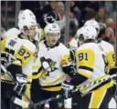  ?? TOM MIHALEK — THE ASSOCIATED PRESS ?? The Penguins’ Sidney Crosby, Evgeni Malkin (71), Jake Guentzel, Kris Letang and Phil Kessel celebrate Malkin’s goal Wednesday against the Flyers.