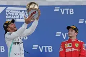  ?? — AP ?? Lewis Hamilton (left) celebrates on top of the podium with third placed Charles Leclerc on Sunday.