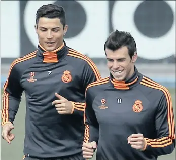  ?? REUTERS ?? REAL BUDDIES: Real Madrid players Cristiano Ronaldo (left) and Gareth Bale run during a training session at Real Madrid’s Valdebebas training grounds outside Madrid. Real Madrid will play Atletico Madrid in the Champion’s League final in Lisbon today.