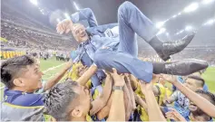  ??  ?? The Perak team lifting their head coach, Mehmed Durakovic, to celebrate their Malaysia Cup 2018 victory after beating Terengganu 4-1 in the final held at the Shah Alam Stadium on Saturday. - Bernama photo