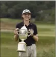  ?? LIBBY O’NEILL — BOSTON HERALD ?? Ryan Downes, 17, of Longmeadow holds the Massachuse­tts Cup after becoming the youngest winner in the 115-year history of the Massachuse­tts Amateur on Friday at Essex County Club.