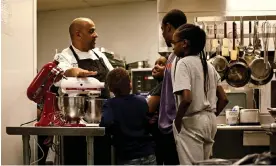  ?? Photograph: Brandon Watson/The Guardian ?? Executive chef Steven Forman of Delaware North and Dakari Singletary teach youth in the Buffalo community how to make simple desserts.