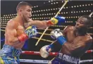  ?? The Associated Press ?? Vasyl Lomachenko, left, punches Guillermo Rigondeaux during the third round of a WBO junior lightweigh­t title match on Saturday in New York.