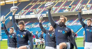  ??  ?? IN THEIR HANDS: Scotland players take part in the captain’s run at Murrayfiel­d yesterday ahead of today’s opener against the Irish.