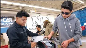  ?? NWA Democrat-Gazette/FLIP PUTTHOFF ?? Sabino Miranda (left), a student at Northwest Technical Institute, shows Jose Albarran, Rogers High School student, auto body sanding techniques Nov. 20 at the NTI campus in Springdale. For more photos, go to www.nwadg.com/photos.