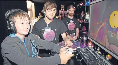  ??  ?? A young fan checks out a new game designed by students from Dundee’s Abertay University.