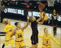  ??  ?? Stanford’s Cameron Brink (22) shoots against Cal’s Evelien Lutje Schipholt (24) and Dalayah Daniels (3) during the first half on Sunday.