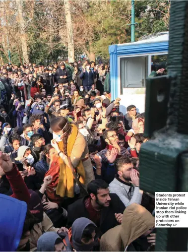  ?? AP ?? Students protest inside Tehran University while Iranian riot police stop them linking up with other protesters on Saturday