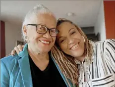  ?? Pam Panchak/Post-Gazette ?? Profession­al bassoonist Monica Ellis, right, with her mother, Marlene Ellis, in her childhood Hill District home.