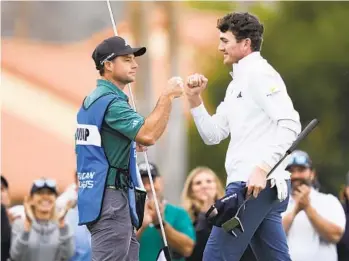  ?? RYAN SUN AP ?? Nick Dunlap (right) bumps fists with his caddie on the ninth green at the La Quinta Country Club course.