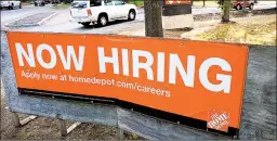  ?? STEVEN SENNE/AP ?? Vehicles drive past a help wanted signWednes­day at a Home Depot store in Boston.