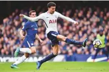  ?? AFP ?? Tottenham Hotspur’s English midfielder Dele Alli shoots to score their second goal during the Premier League match against Chelsea yesterday.