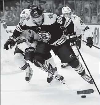  ?? MICHAEL DWYER/AP PHOTO ?? Kevan Miller of the Bruins (86) battles Ryan Carpenter of the Sharks, left, for the puck during the first period of Thursday’s game at Boston. The Bruins won 2-1.