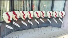  ?? [JIM WOODS/DISPATCH] ?? Nine white wreaths of flowers labeled with the names of victims stand outside the Ohio EPA office in Dayton.